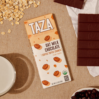 Coffee Toffee Crunch Laying next to unwrapped chocolate bar and oats.