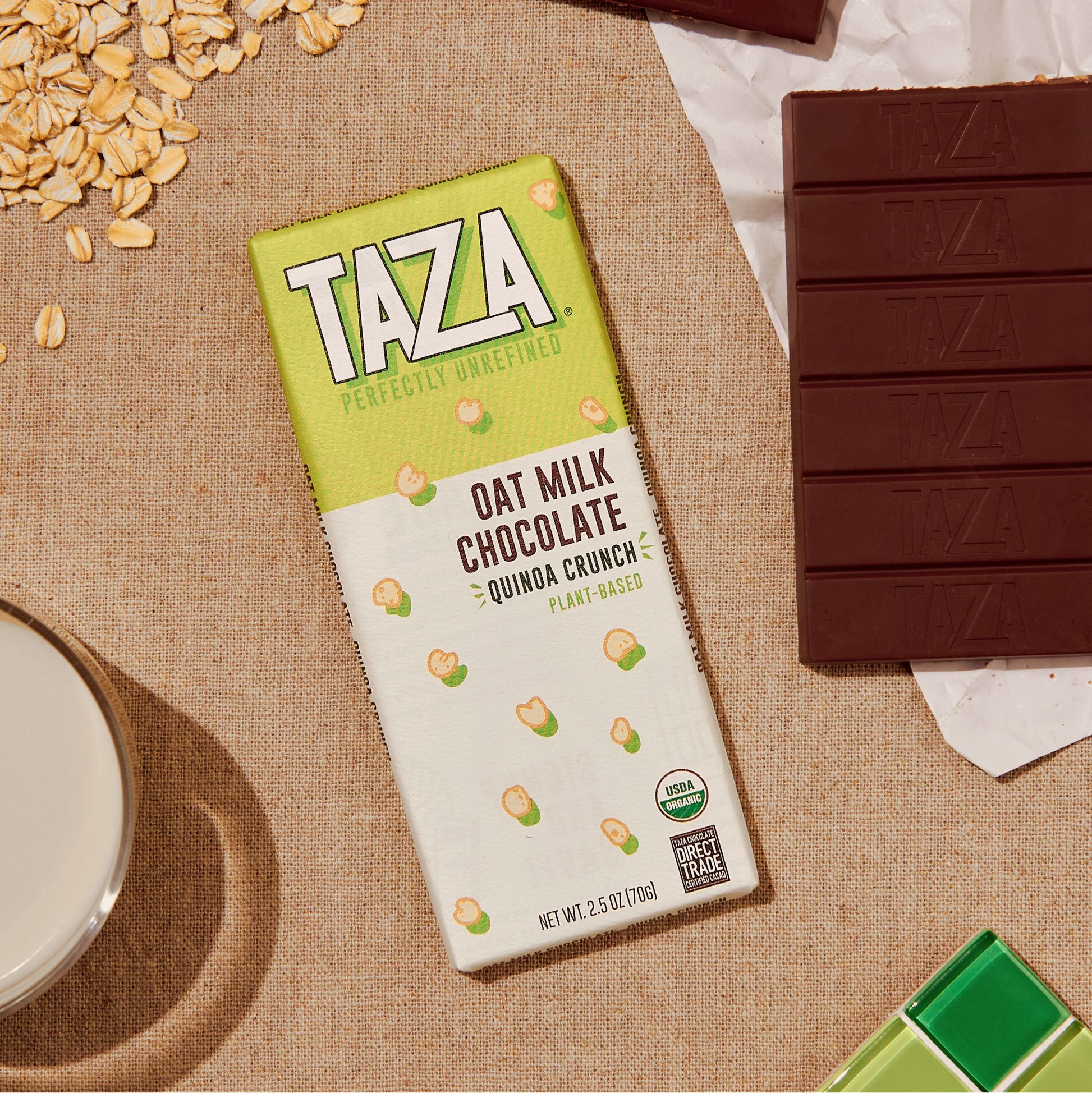 Quinoa Crunch Oat Milk bar next to unwrapped chocolate bar