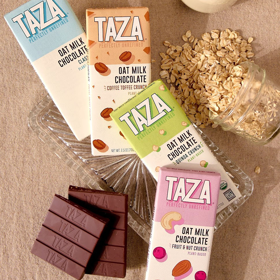 Taza Oat Milk Bars spread out with Oats and Chocolate.