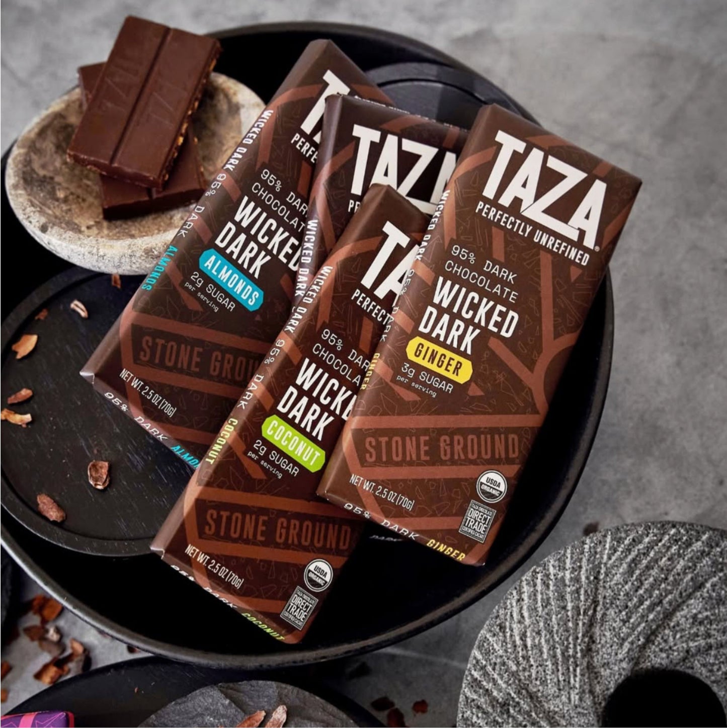Wicked Dark Ginger Bar laying amongst similar bars and unwrapped chocolate.