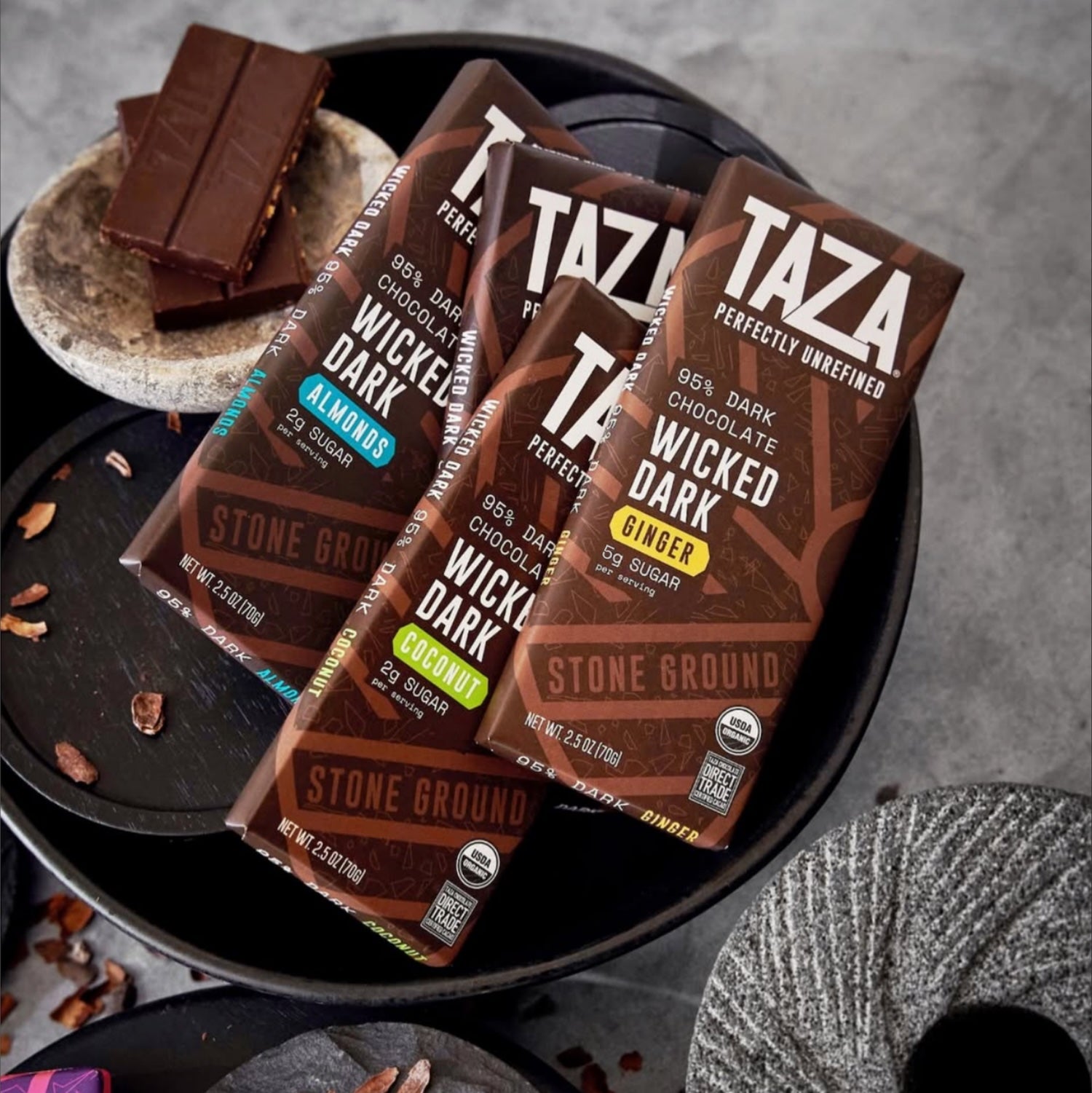 Wicked Dark Bar lying amongst similar products and unwrapped chocolate.